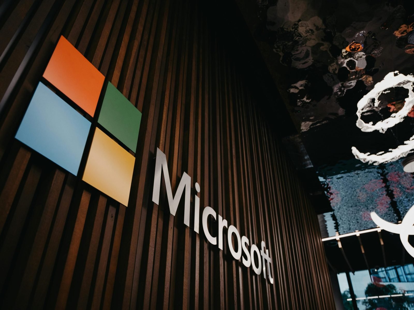 Interior view of Microsoft office with logo on wooden wall in Brussels, Belgium.