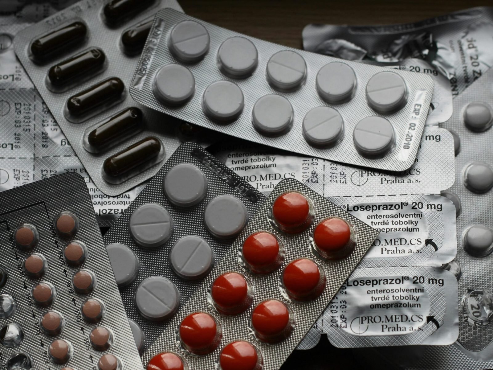 Close-up of various pills in blister packs showcasing medical and healthcare themes.