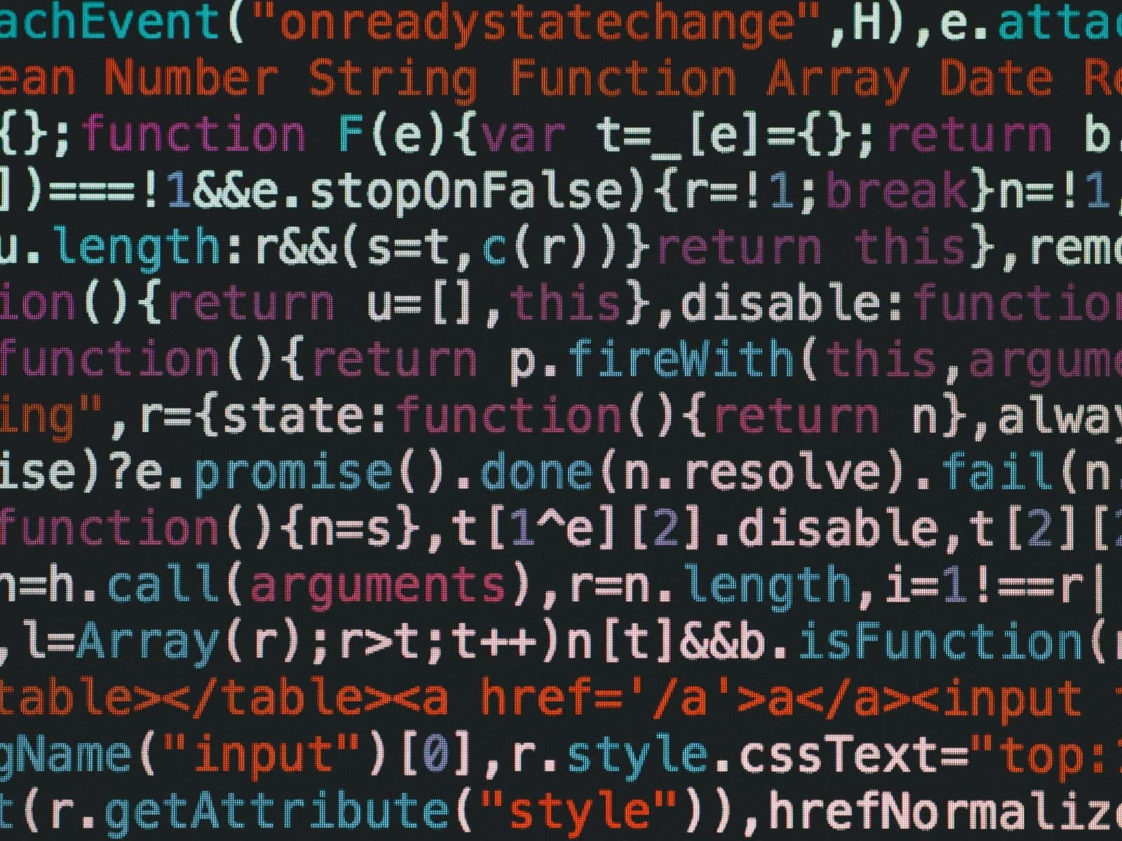 Close-up of colorful coding text on a dark computer screen, representing software development.